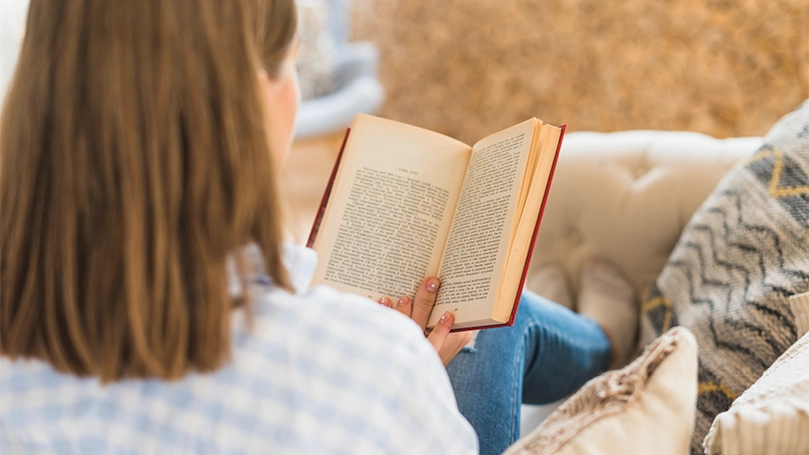 An image of a woman reading a book