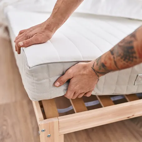 man placing mattress