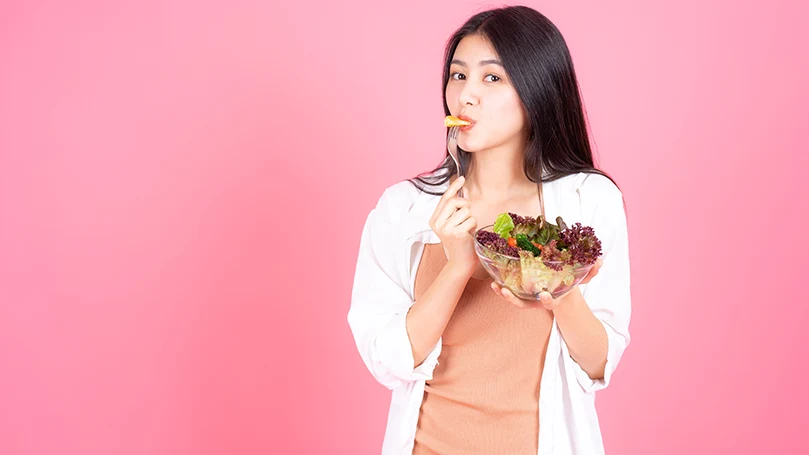 an image of a woman eating healthy food before bed