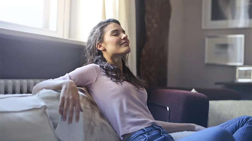 An image of a woman practicing breathing techniques.