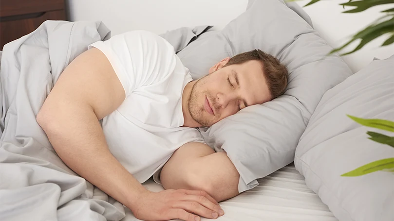 a man sleeping comfortably in his bed