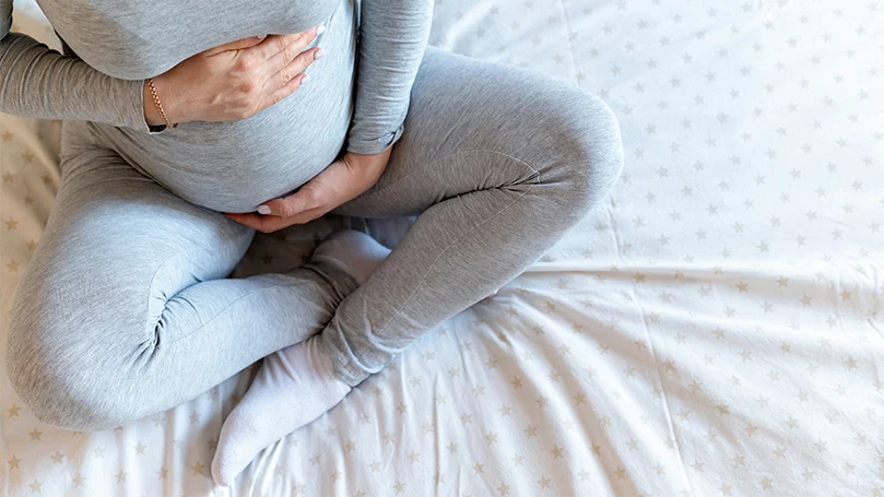 a-pregnant-woman-holding-her-stomach