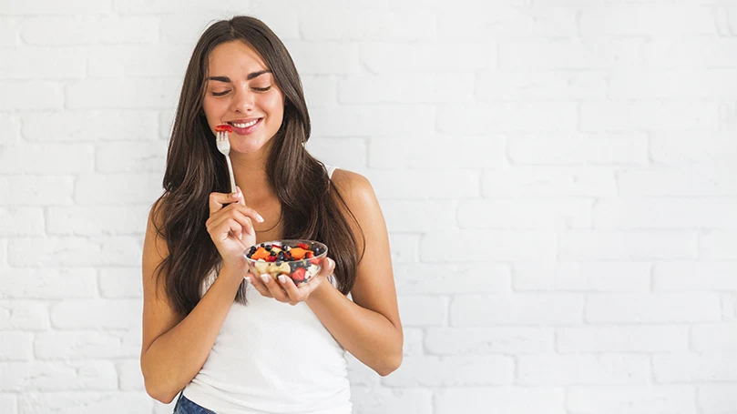 an image of a young woman eating healthy food to remember dreams