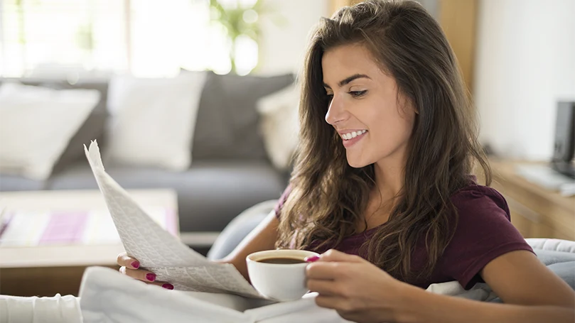 An image of a young woman drinking her coffee.