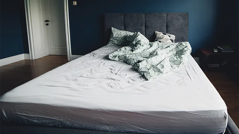 An image of a bedroom with a bed and a refurbished mattress .