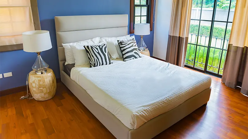 An image of bedroom with a lot of natural light.