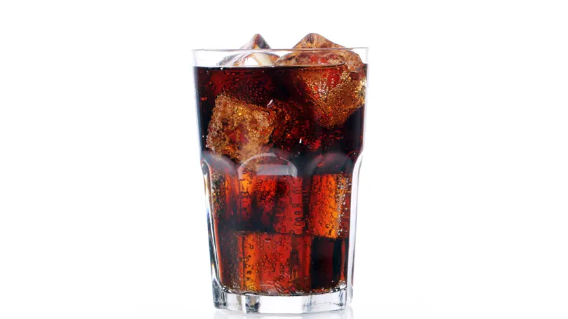 a glass of soda cola drink.