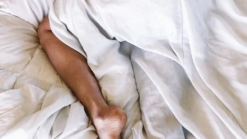 An image of a person sleeping in bed