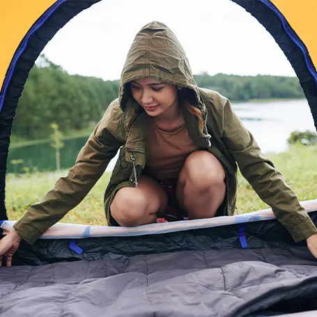 A woman setting up a tent