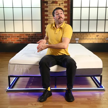 An image of a TSA reviewer sitting on the OTTY Pure Hybrid Bamboo & Charcoal Premium Mattress